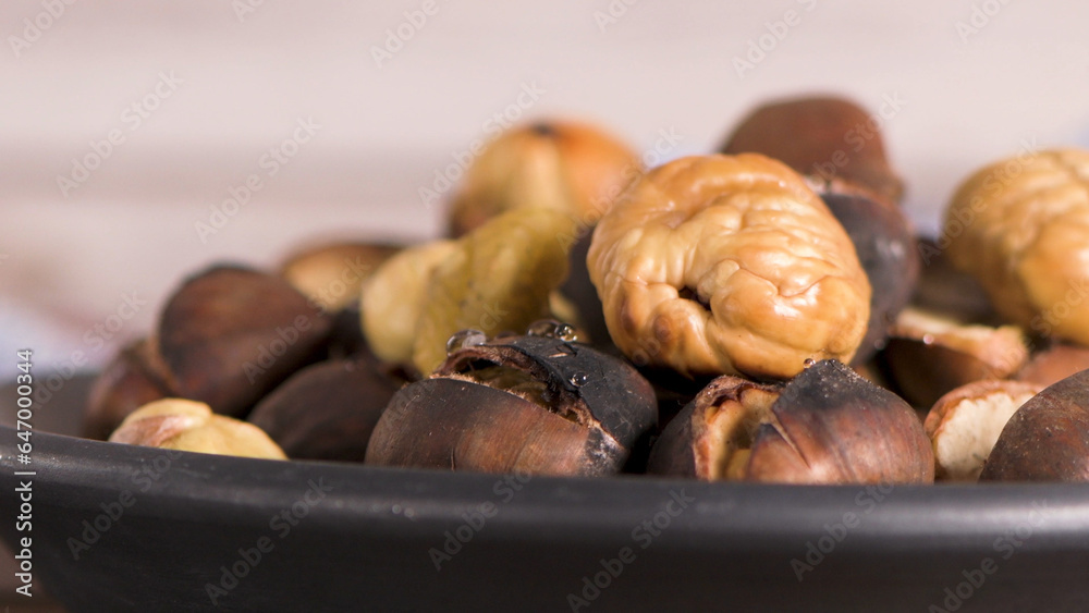 Fototapeta premium Roasted chestnuts in cast iron pan