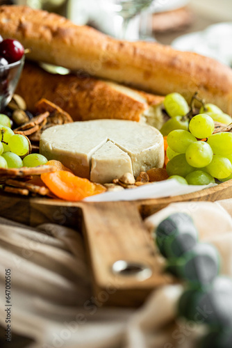 Brie cheese surrounded by grapes 