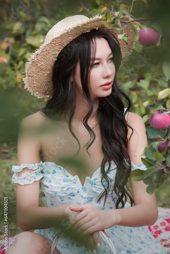 Portrait of a young sexy woman in an apple orchard.
