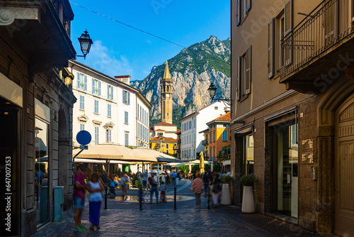 View of old town streets of Italian city of Lecco on background of San Martino mountain at sunny day