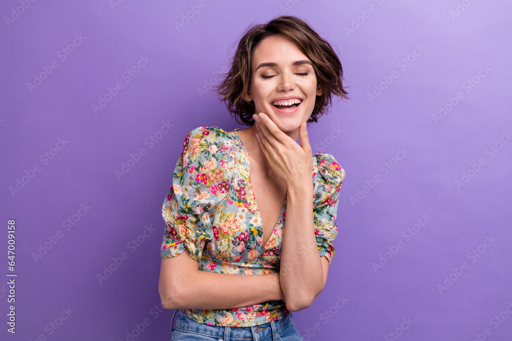 Photo portrait of lovely young lady touch chin laughing have fun wear trendy flower print garment isolated on violet color background Photo portrait of lovely young lady touch chin laughing have fun wear trendy flower print garment isolated on violet color background