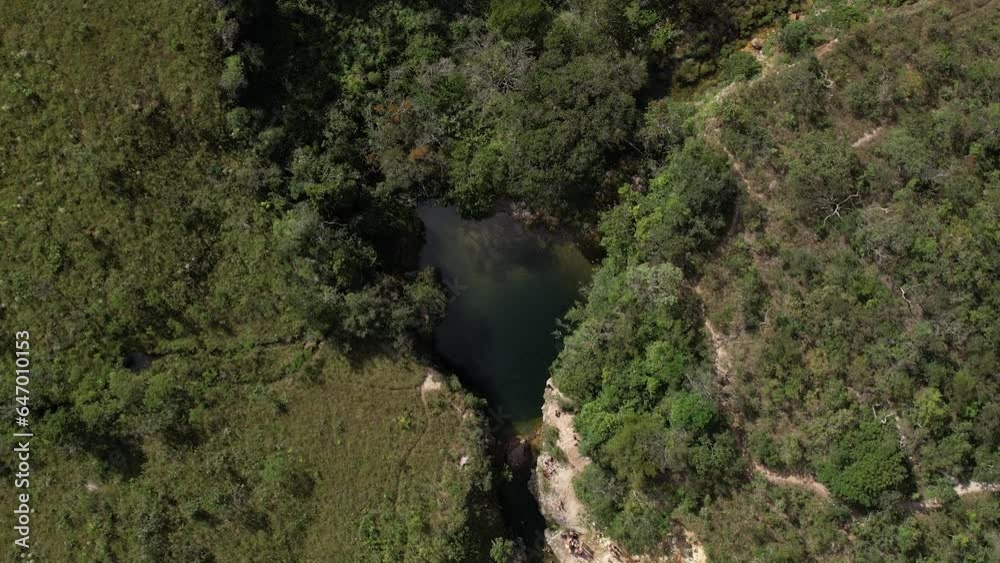 aerial view of Poço das Esmeraldas in Chapada dos Veadeiros Goiás Brazil green water, sunny day, waterfall, rocks and cerrado vegetation
