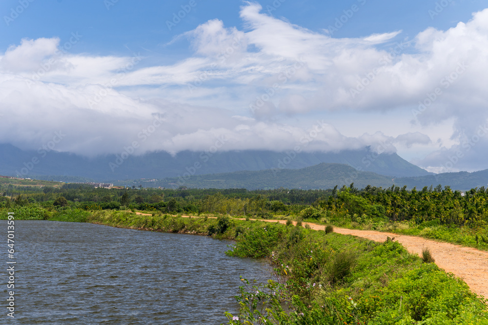 view of river and road running through forest and mountainous landscape view of river and road running through forest and mountainous landscape