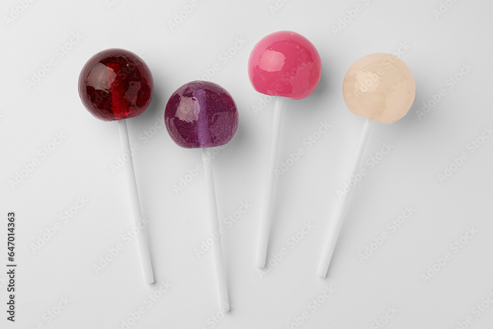 Tasty lollipops on white background, flat lay Tasty lollipops on white background, flat lay
