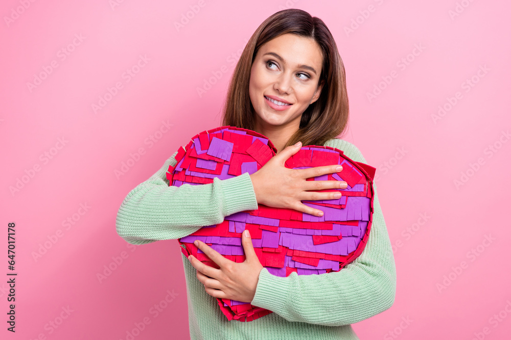 Portrait of lovely girlfriend nice person hugs her surprise pinata heart shape looking empty space dreams isolated on pink color background Portrait of lovely girlfriend nice person hugs her surprise pinata heart shape looking empty space dreams isolated on pink color background