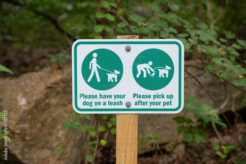 Sign - Please keep your dog on a leash and Please pick up after your pet. 