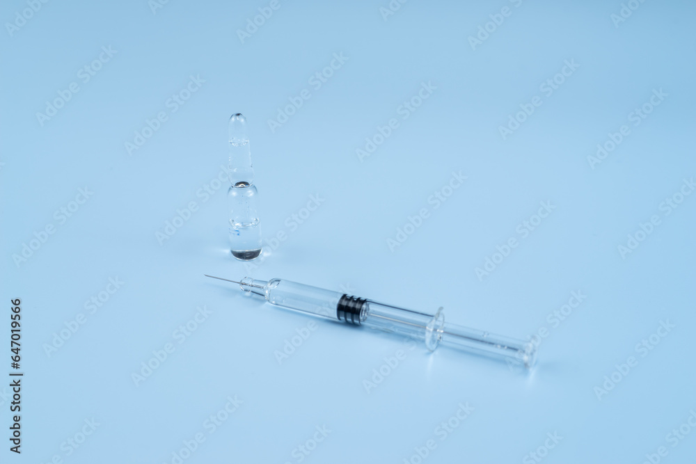 Ampoules filled with medicine and syringes