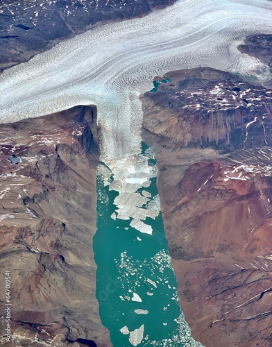 Aerial of Greenland glacier melting and breaking up into a fjord