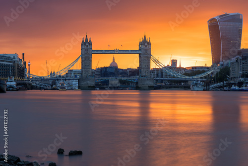 London, England, the famous Tower Bridge at sunrise with orange sky