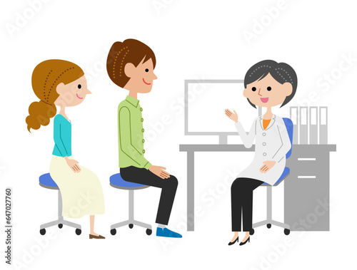 診察室で女性医師に説明を受ける若い夫婦