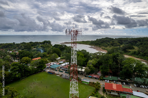 Close up aerial footage of a Cellular, telecommunications, g5 tower in the Mountain and beach of Costa Rica