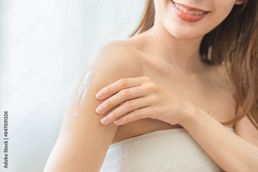 Health care, beauty smile asian young woman, girl wrapped in towel after shower bath, spa relax at home, hand applying, putting moisturizing lotion on her shoulder. Skincare routine in the morning. Health care, beauty smile asian young woman, girl wrapped in towel after shower bath, spa relax at home, hand applying, putting moisturizing lotion on her shoulder. Skincare routine in the morning.