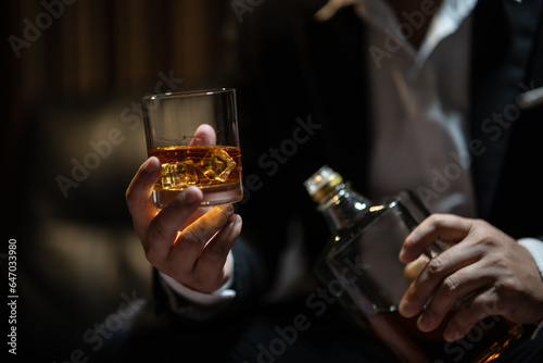 Businessmen in suits drinking Celebrate whiskey.