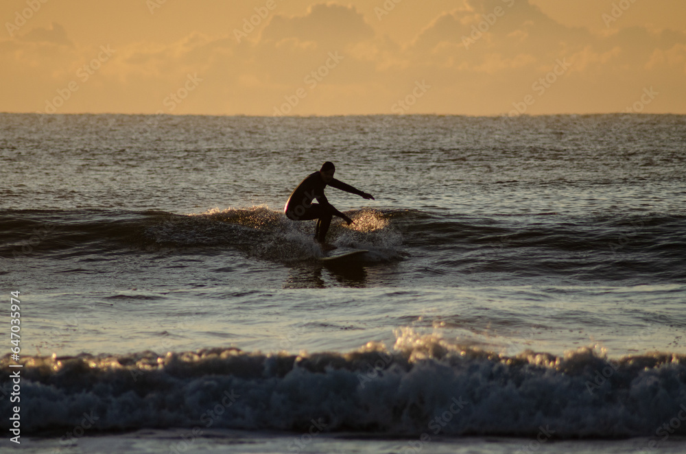 man surfing in Sunshine Coast Queensland Australia at sunrise
