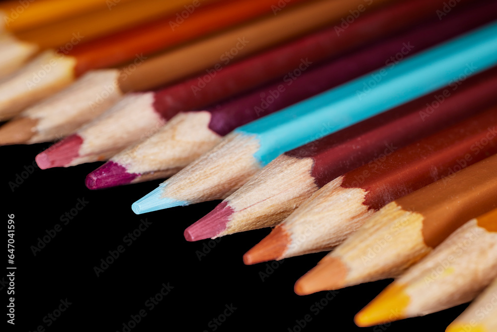 Row of Brown Colored Pencils with one blue pencil aligned together Row of Brown Colored Pencils with one blue pencil aligned together