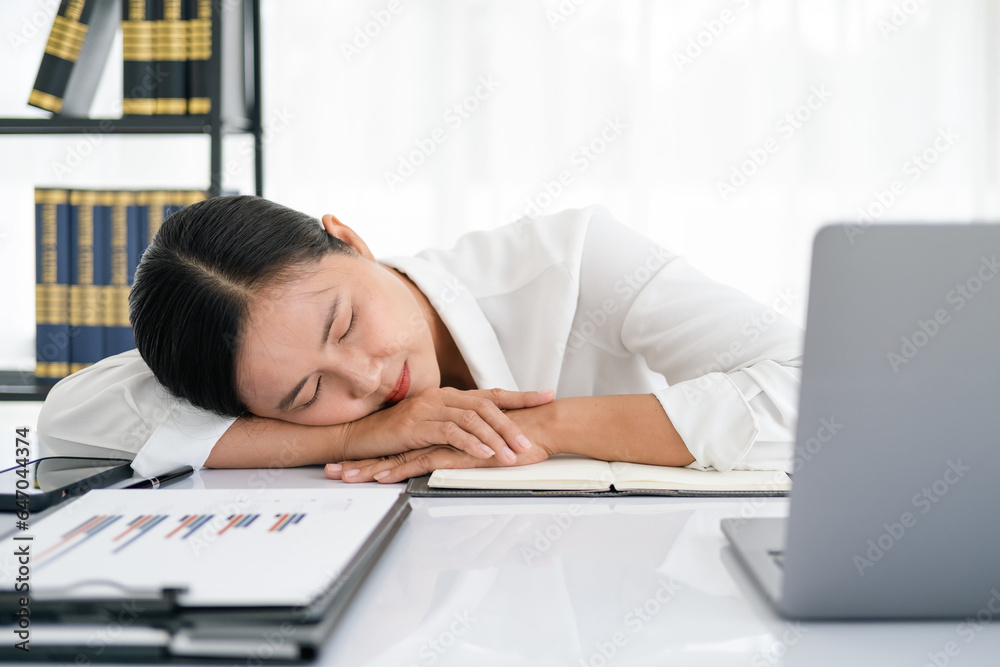 tired business woman sleepy and bored from sitting at a desk for a long time and has office syndrome tired business woman sleepy and bored from sitting at a desk for a long time and has office syndrome