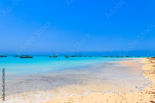 View of tropical sandy Nungwi beach and traditional wooden dhow boats in the Indian ocean on Zanzibar  Tanzania