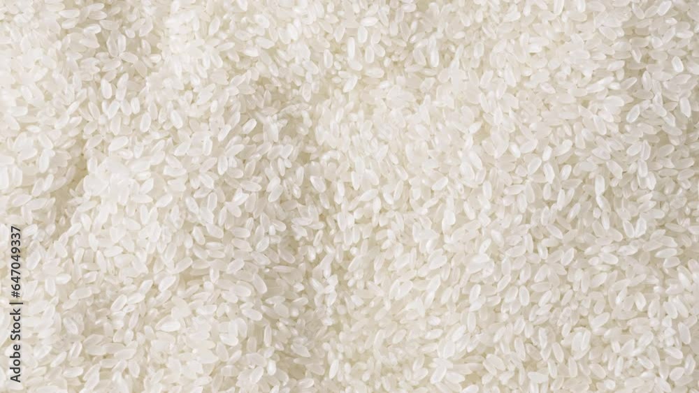 Closeup white uncooked rice rotating. Closeup white uncooked rice rotating.