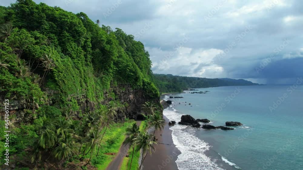 Flying circling on north coast line from Sao Tome with the Santa Catarina tunel as background,Africa