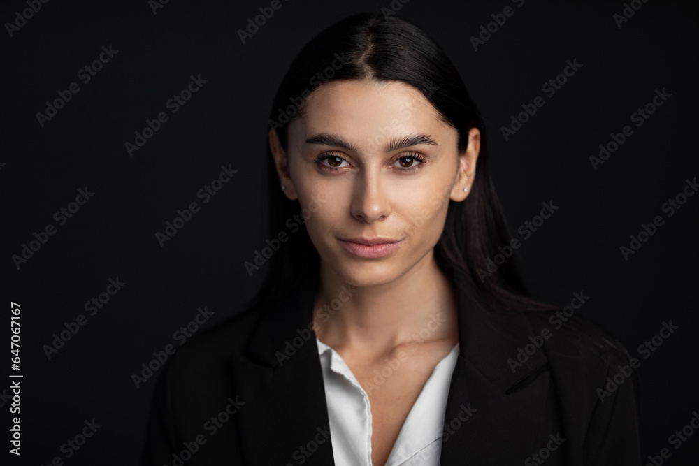 Closeup portrait of a beautiful young fashion woman posing at studio on black. Closeup portrait of a beautiful young fashion woman posing at studio on black.