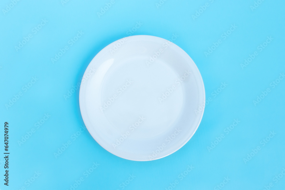 Empty plate isolated on blue background, after some edits. Empty plate isolated on blue background, after some edits.