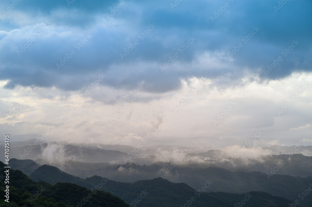 Layers of mountains and layers of clouds combine to form a painting. View of the mountains and sea from the highlands of Ruifang District. Taiwan.