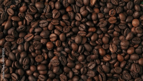 Closeup shot of aromatic roasted coffee beans background. Advertising area  template.