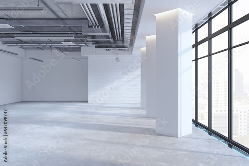 Quadro em tela Light empty concrete office premises interior with panoramic windows, city view, shadows and mock up place on wall