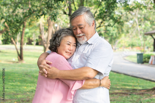 Asian healthy senior couple relaxing in the park together.