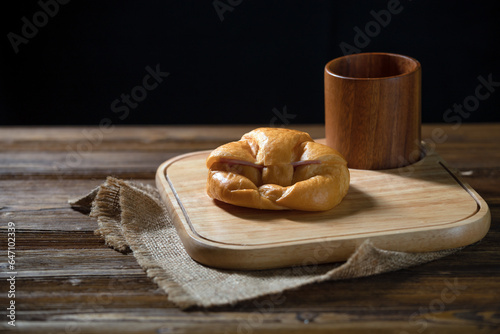 Delicious Freshly Baked Croissants and cup on Rustic Wooden Platter