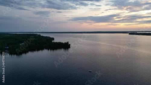 Sailing On The Quiet Lake Rosseau During Sundown In Ontario, Canada. Aerial Drone Shot photo