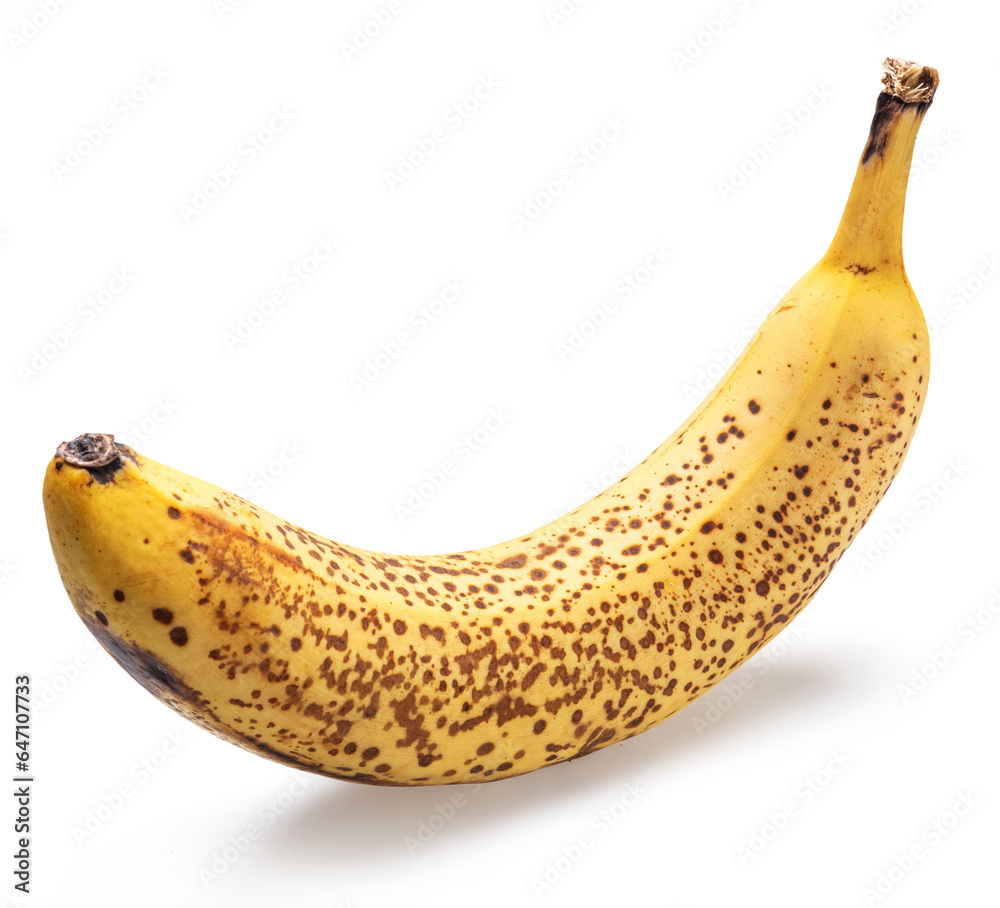 Banana with black spots at the pick of its sweetness isolated on white.