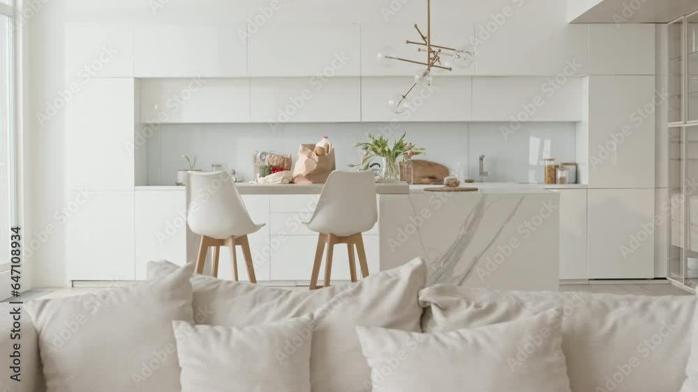 Interior of modern kitchen-living room combo with stylish minimalist design in white colors, no people there