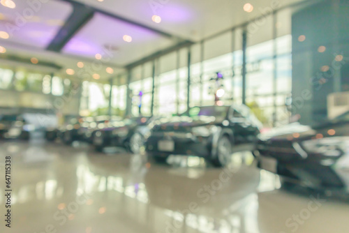 new cars in showroom interior blurred abstract background © Piman Khrutmuang