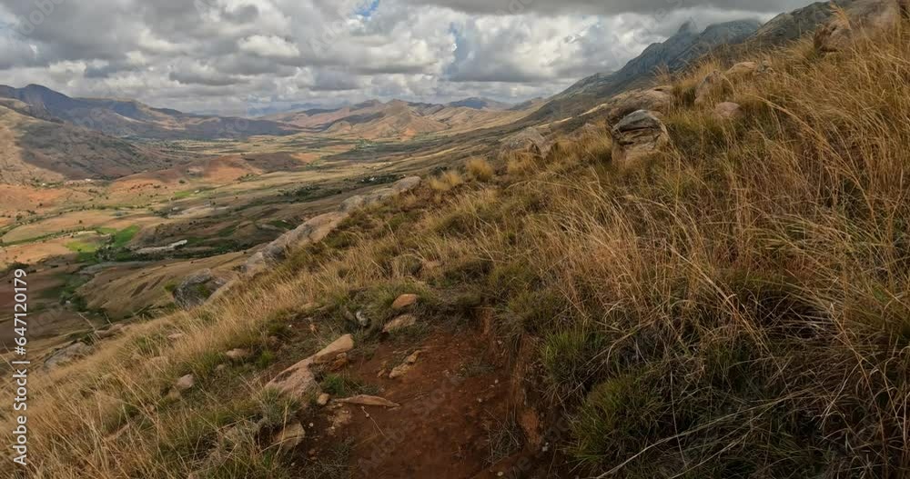 Hiking Andringitra national park, Madagascar, mountain landscape, descent trail from high peak. Walking tourist trail in Andringitra mountains. Madagascar wilderness landscape.