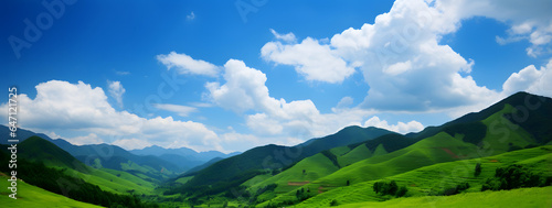 Lush green grass covering hills, bathed in the glow of a brilliant sun. The azure skies above are adorned with wispy clouds, and the sun's rays perfect day in the great outdoors.