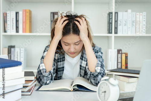 Картината върху платно Asian student woman have anxiety because of exams, female prepare for test and learning lessons in the library