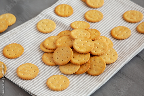 Round Crispy Crackers with Sea Salt on a gray background, side view.