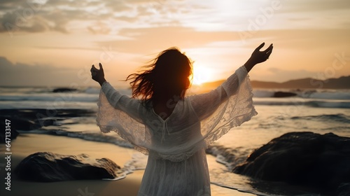 Woman wearing white gawn with loose hair with wide open arms infront of beautiful beach. Created with Generative AI Technology