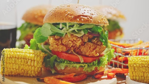 Fresh and tasty crispy chicken burger with melted cheese, lettuce, tomato, argula photo
