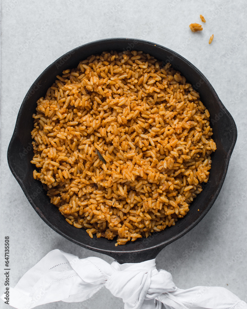 Jollof rice in a cast iron skillet, homemade party nigerian jollof rice