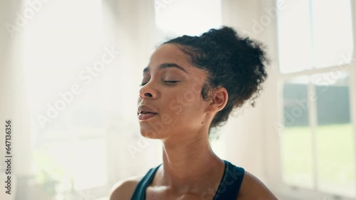 Face, yoga and meditation to relax with a woman closeup in a home for fitness, mindfulness or awareness. Exercise, zen and breathing with a young person in an apartment for health, wellness or peace photo