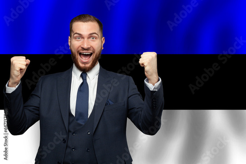 Estonian happy businessman on the background of flag of Estonia Business, education, degree and citizenship concept photo