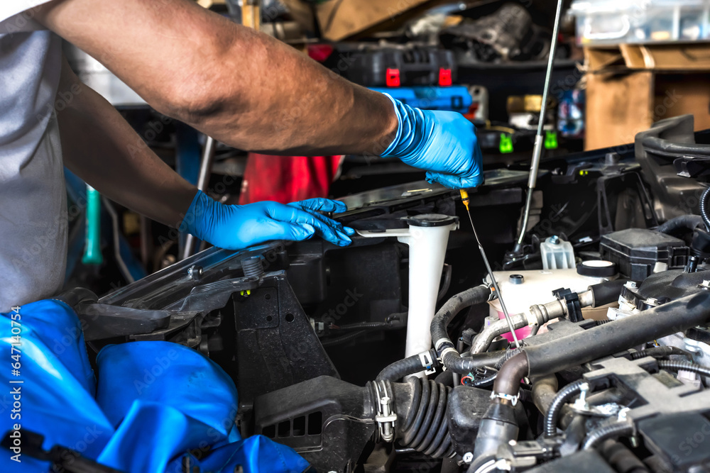 Auto mechanic using wrench working and fixing car in auto repair Auto mechanic using wrench working and fixing car in auto repair