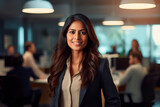 indian asian businesswoman, in the office. Smiling. Light