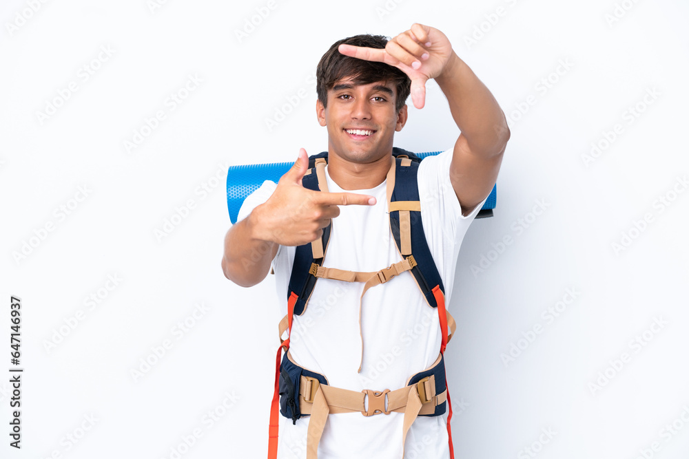 Young mountaineer woman with a big backpack over isolated white background focusing face. Framing symbol Young mountaineer woman with a big backpack over isolated white background focusing face. Framing symbol