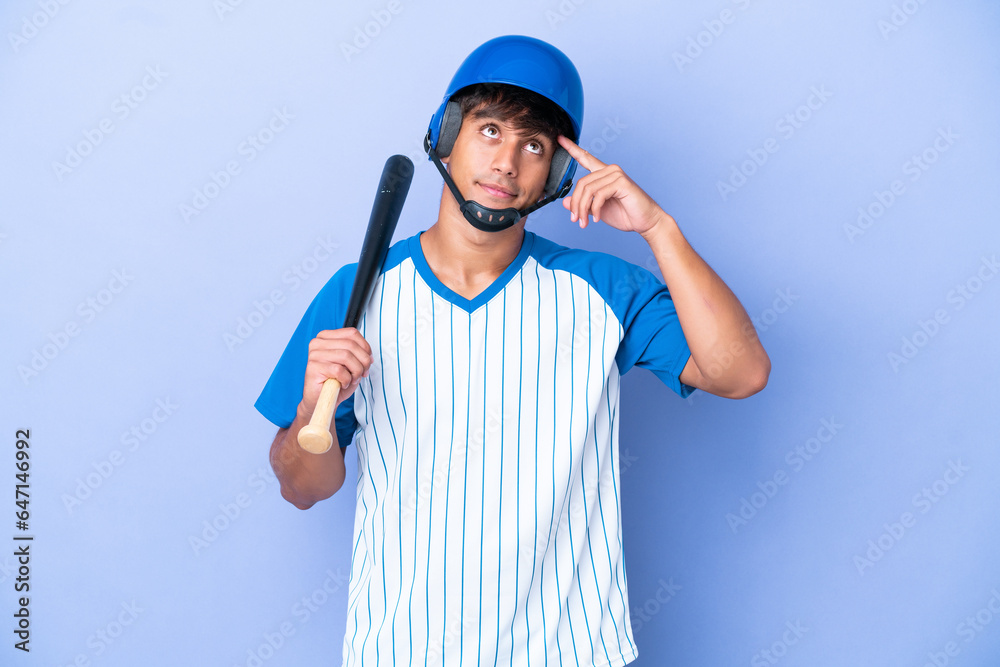 Baseball caucasian man player with helmet and bat isolated on blue background having doubts and thinking Baseball caucasian man player with helmet and bat isolated on blue background having doubts and thinking