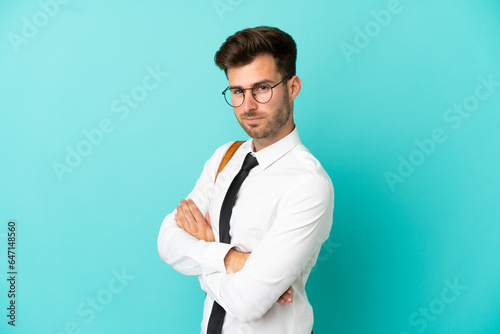 Business man over isolated background with arms crossed and looking forward