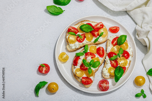 Fresh bread sandwiches with tomato cherry, cream cheese and basil leaves. Morning breakfast concept