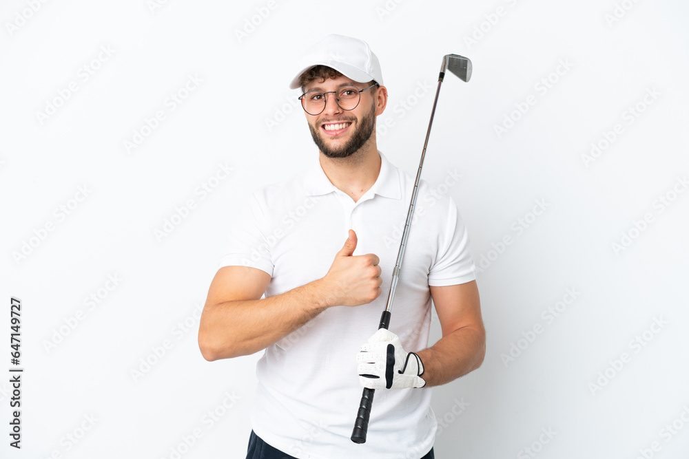 Handsome young man playing golf isolated on white background giving a thumbs up gesture Handsome young man playing golf isolated on white background giving a thumbs up gesture